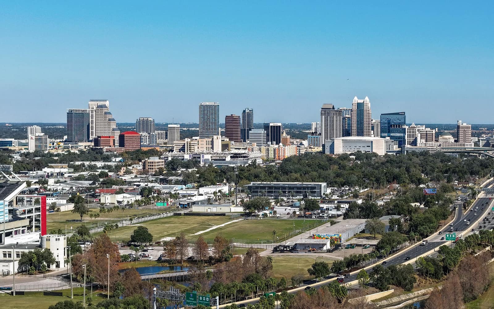 Downtown Orlando skyline with clear blue sky, showing the city's high-rises and urban landscape